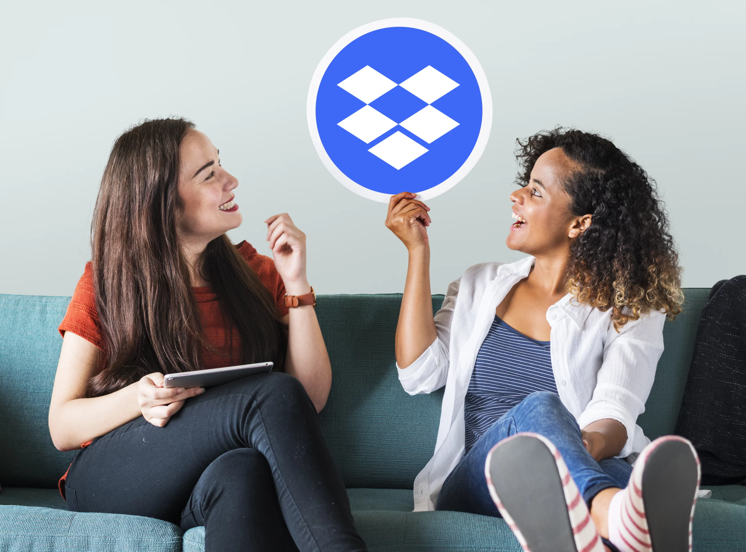women holdingn up dropbox icon